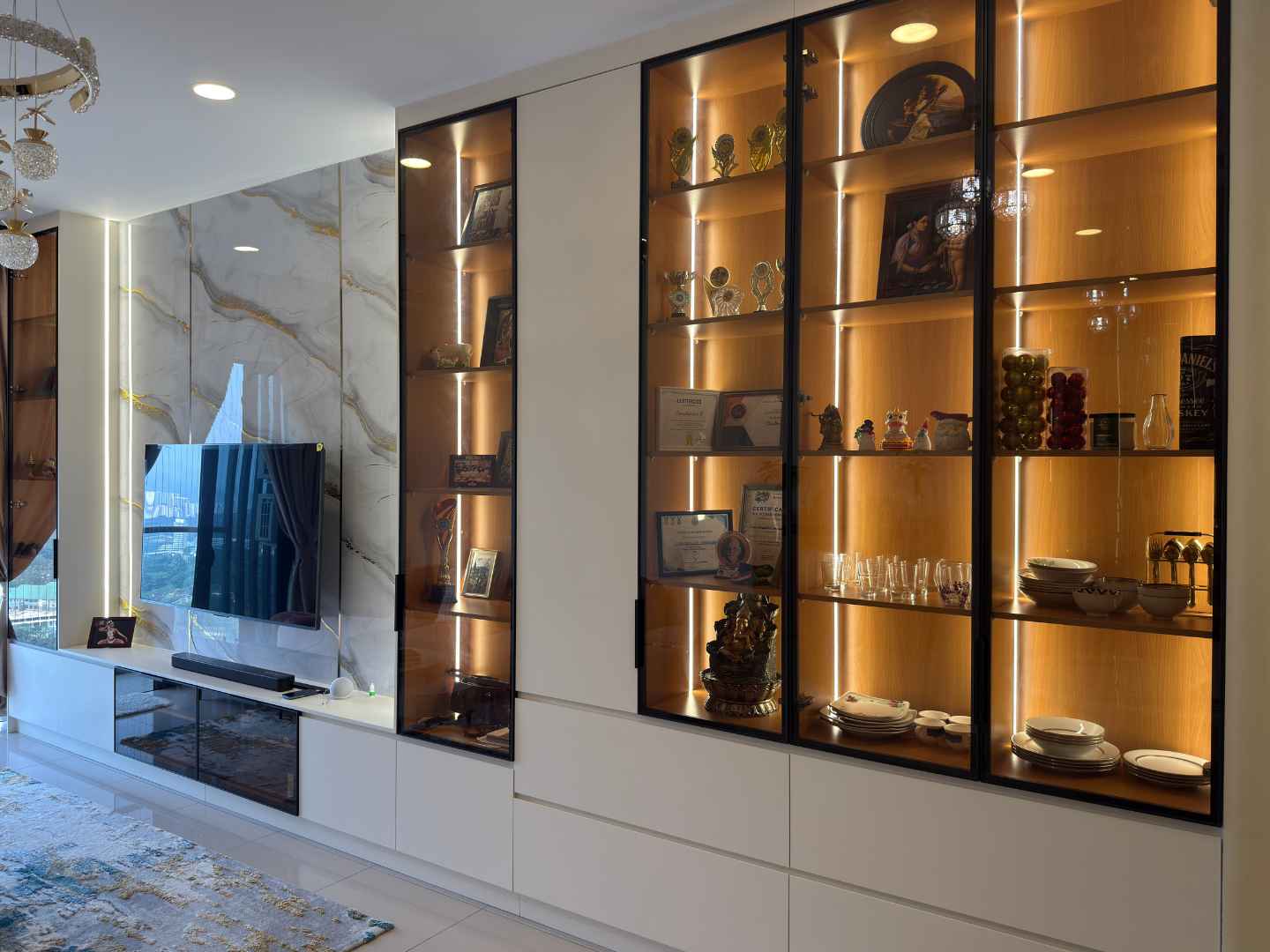 Built-in glass display cabinet with LED lighting showcasing trophies and collectibles in modern living room